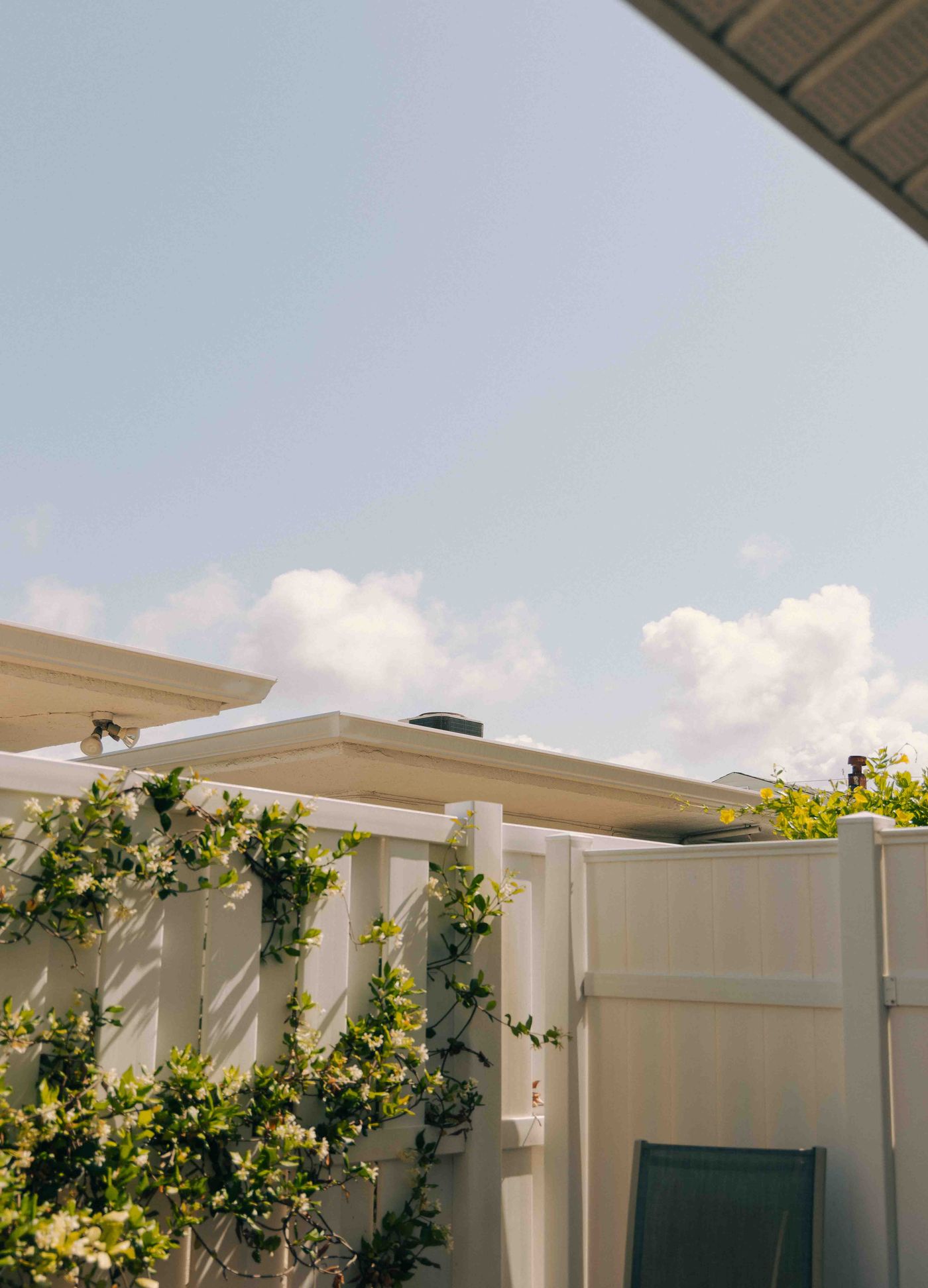 White vinyl privacy and picket fence along a residential backyard